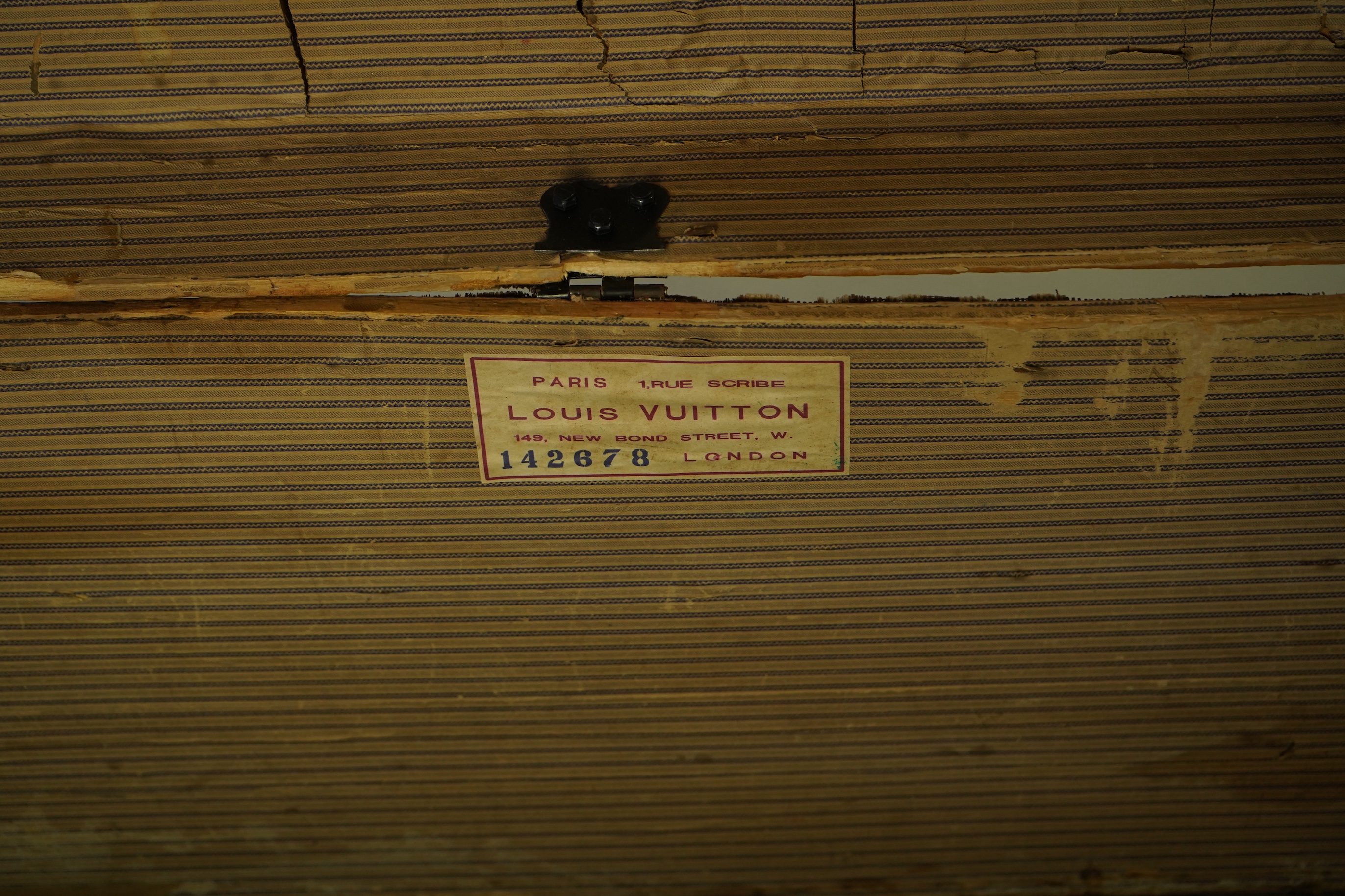 A vintage Louis Vuitton trunk with paper label to the interior numbered 142678, height 43cm, width 90cm, depth 48cm